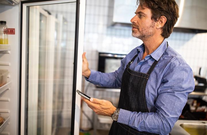 Restaurant Owner Opening Fridge